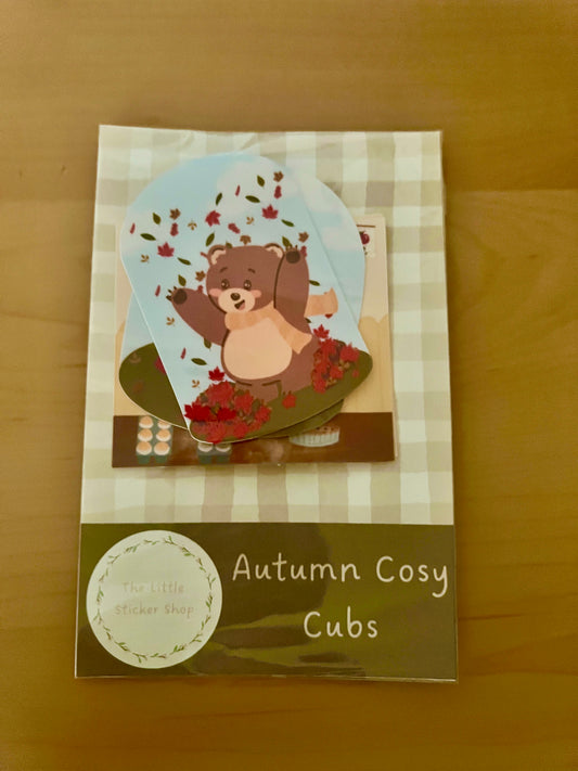 Packaging of 'Autumn Cosy Cubs' with a bear illustration on a checkered background