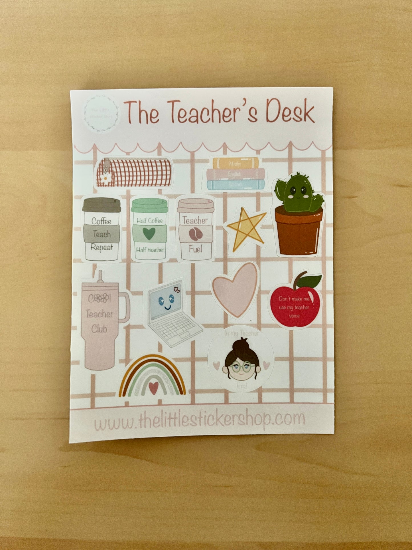 Sheet of stickers for teachers with various illustrations on a wooden surface